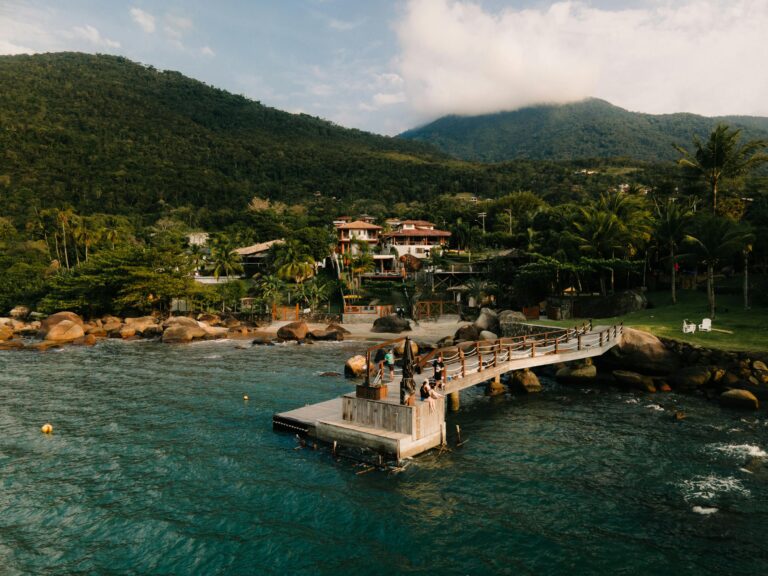 Pier and calm sea surrounded by forested hills in Ilhabela