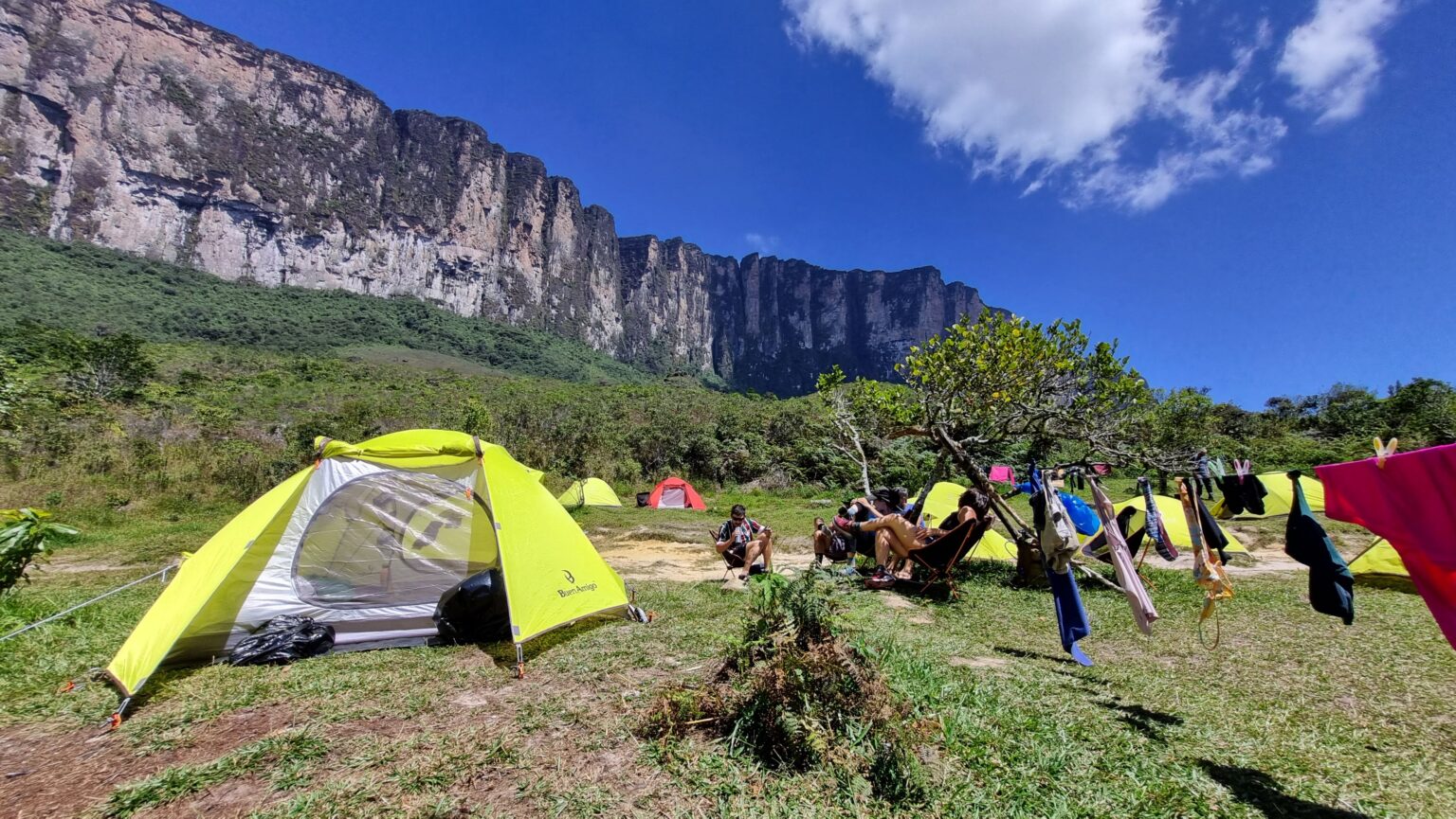 Camp in the grassland beneath the towering cliffs of Mount Roraima
