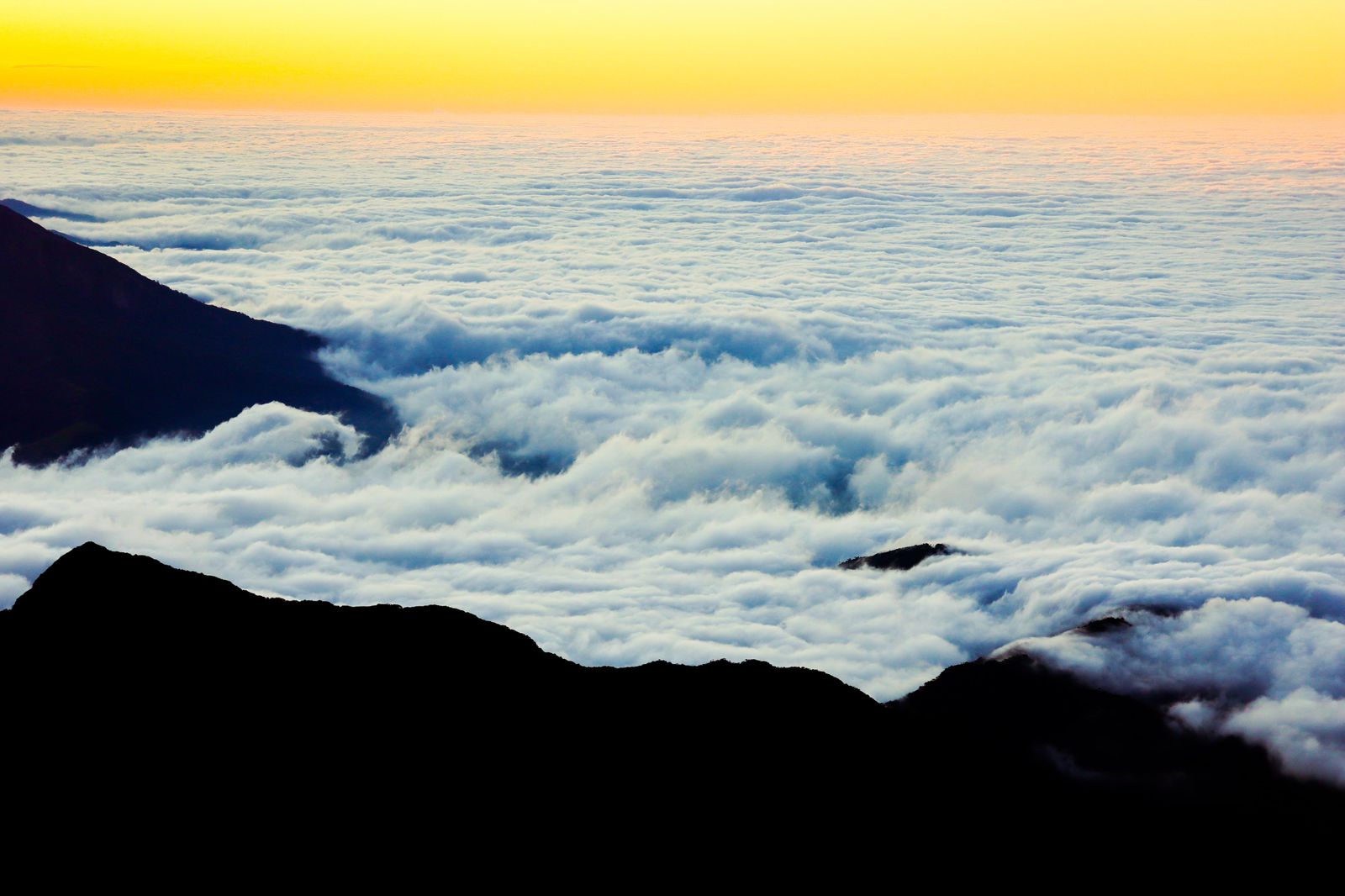 Sunrise above a sea of clouds seen from Pico dos Marins