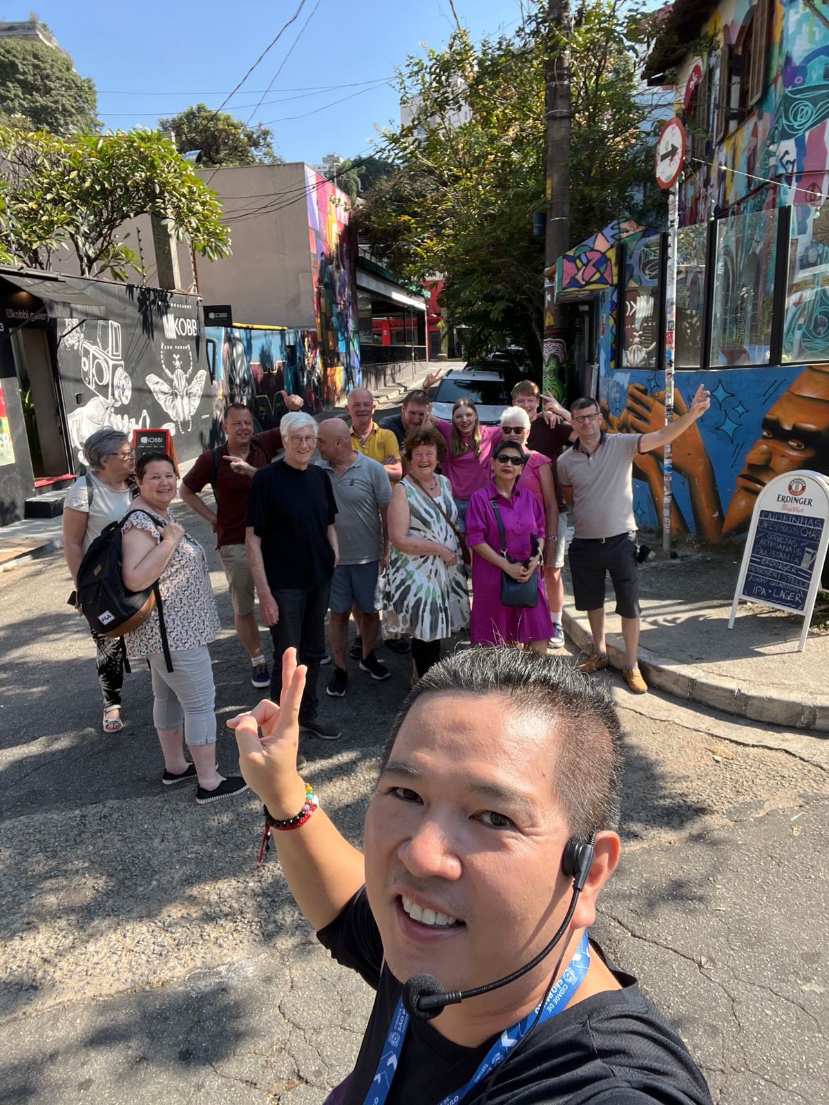 AMTOURS guide taking a selfie with a group of travellers on a street-art walking tour in São Paulo